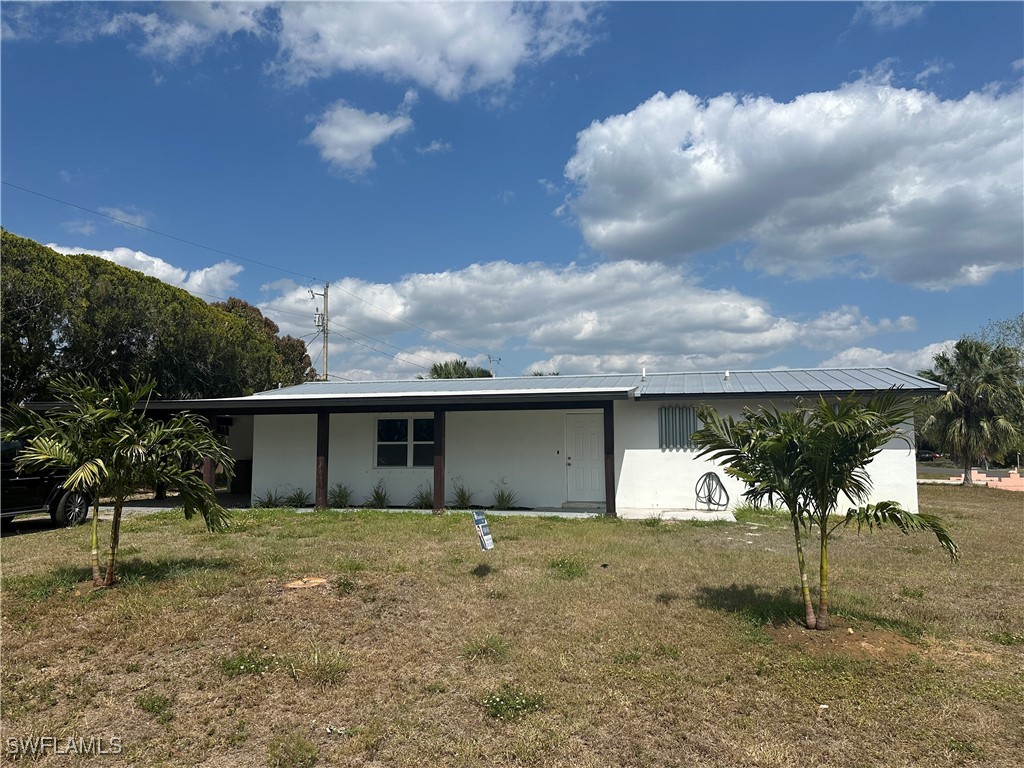100 Wyoming Road Lehigh Acres, FL 33936 - Photo 4 of 38 a view of a house with a backyard