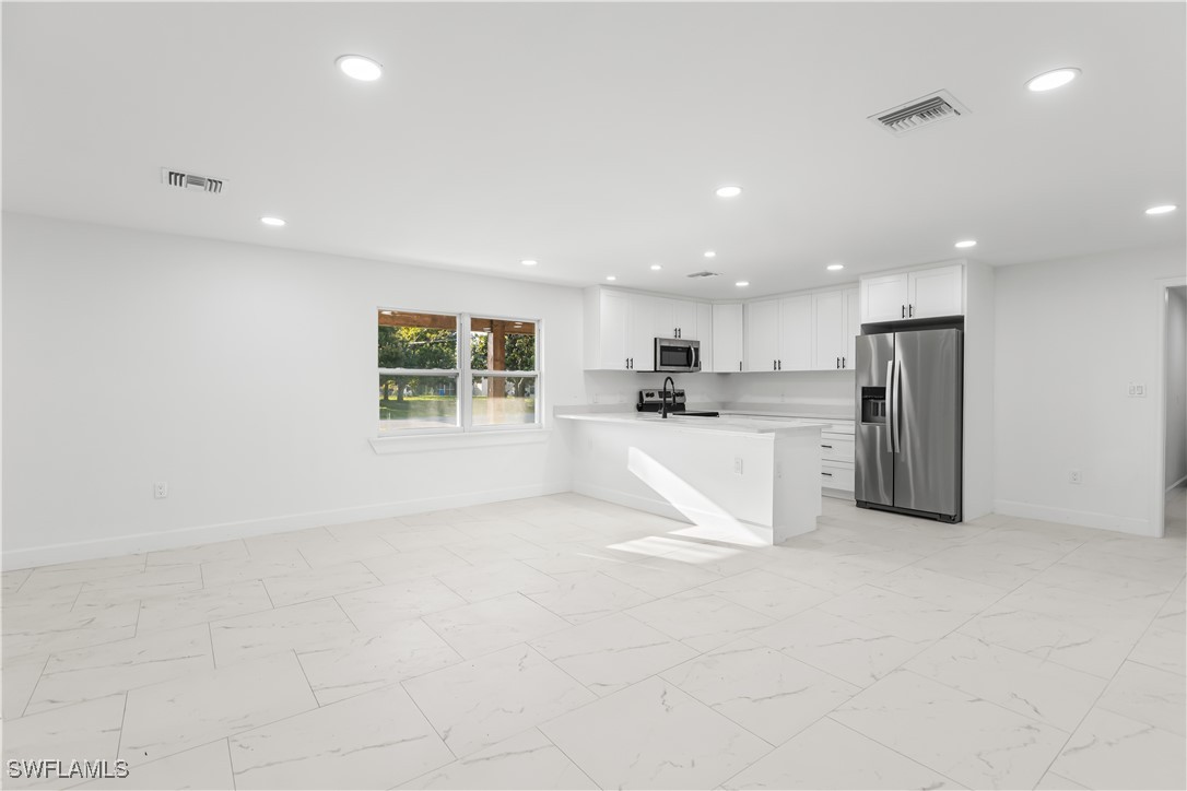 100 Wyoming Road Lehigh Acres, FL 33936 - Photo 10 of 38 a view of kitchen with stainless steel appliances refrigerator oven and cabinets