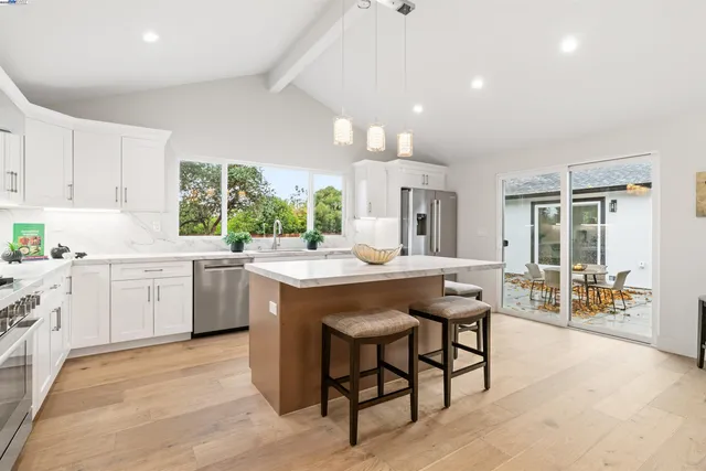 a kitchen with a stove sink and cabinets