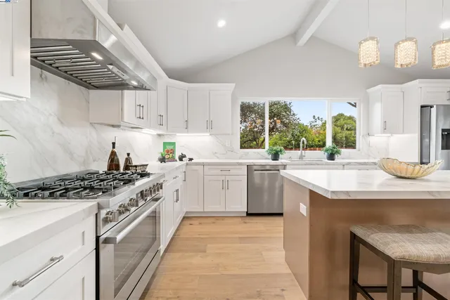 a kitchen with a table chairs sink and cabinets