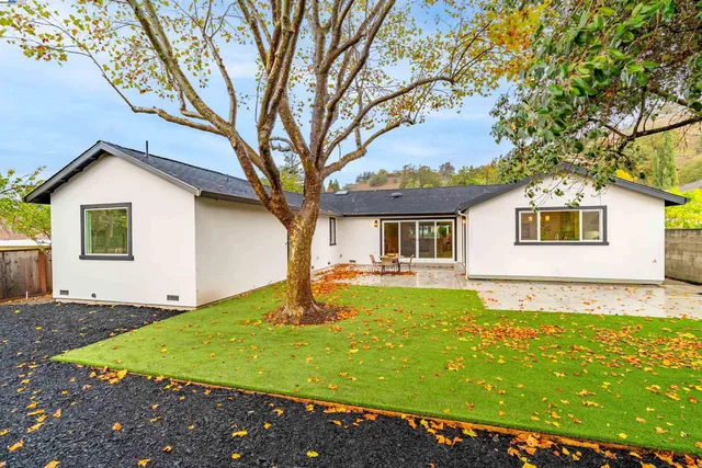a front view of house with yard and trees