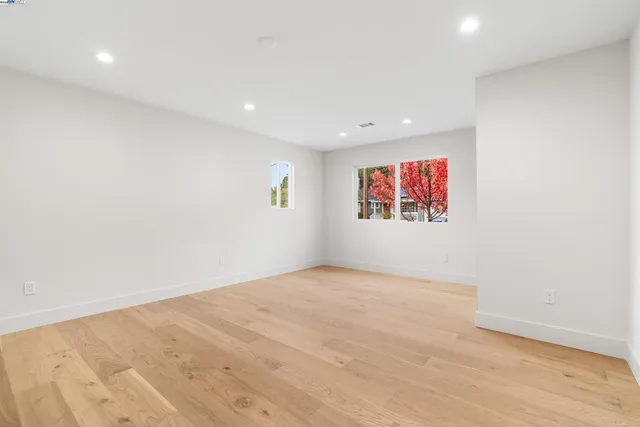 a bathroom with a granite countertop sink a toilet a mirror a vanity and shower