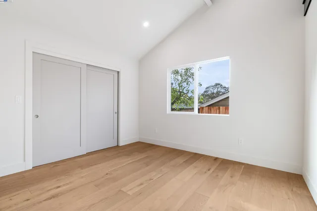a bedroom with a bed couch and a window