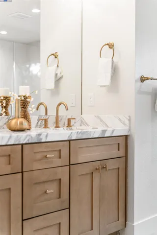 a spacious bathroom with a double vanity sink and a mirror
