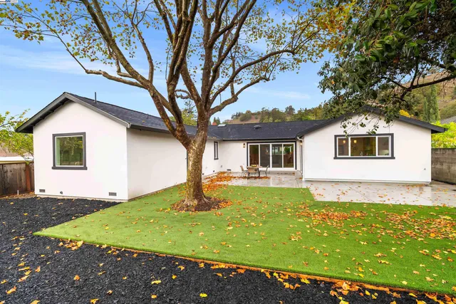 a front view of house with yard and trees