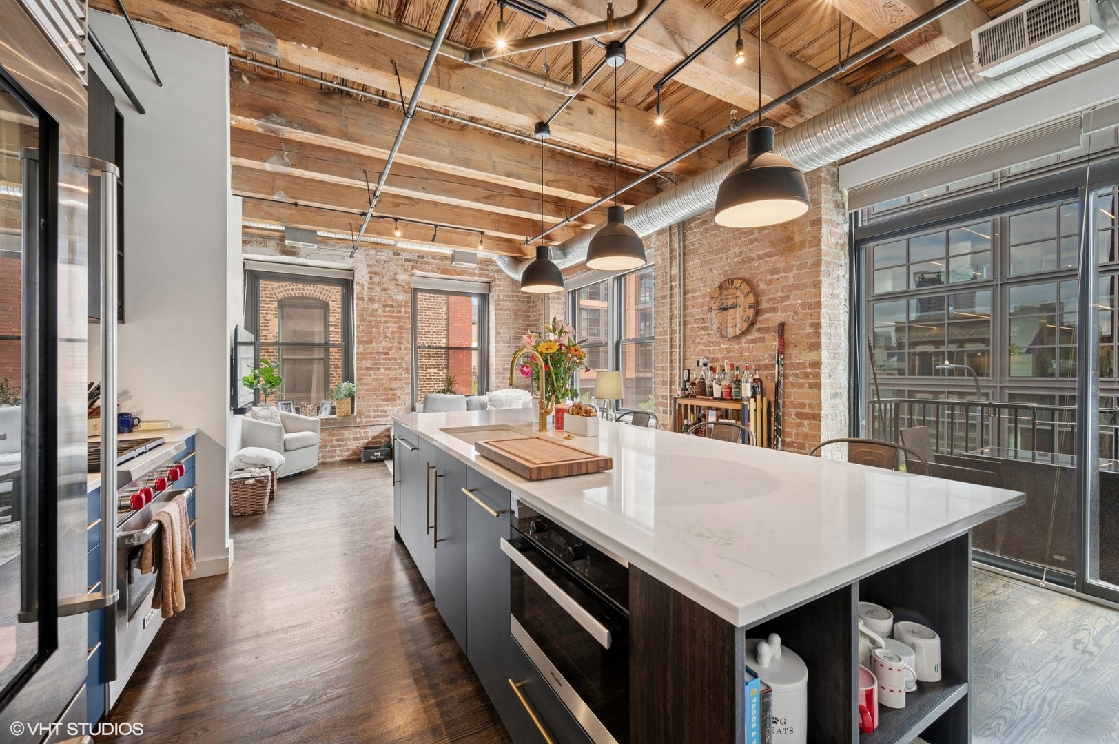 106 North Aberdeen Street, Unit 3A Chicago, IL 60607 - Photo 3 of 13 a large kitchen with stainless steel appliances a stove and wooden floor