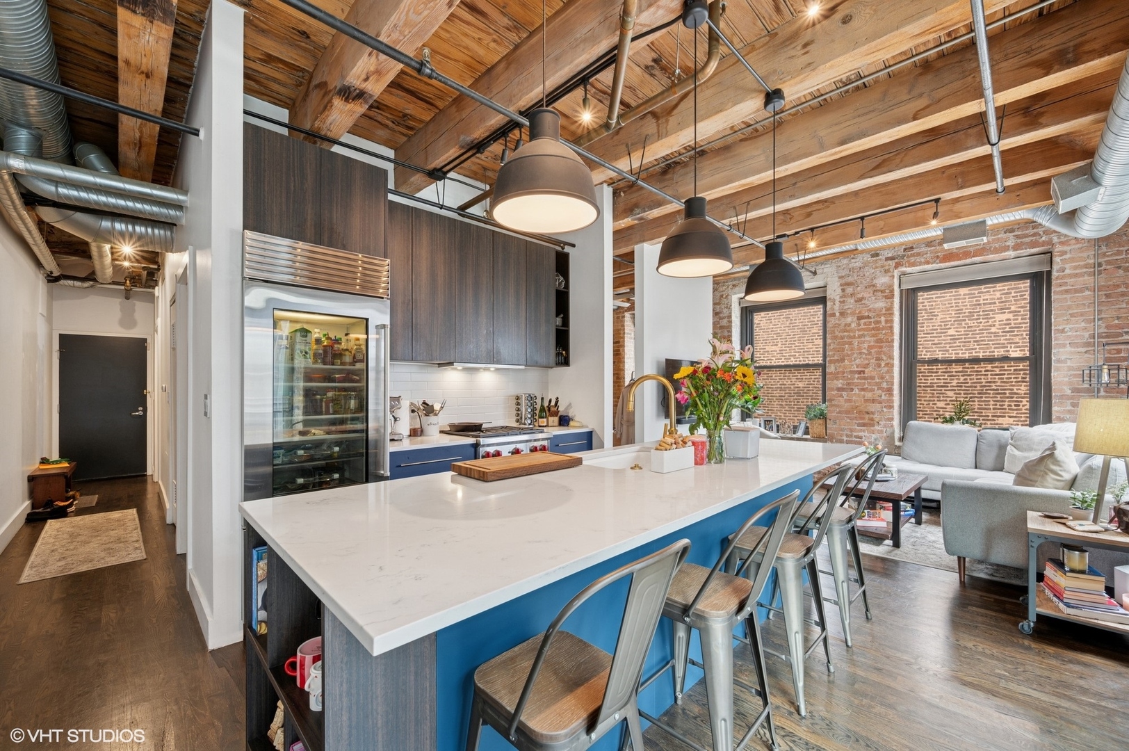 106 North Aberdeen Street, Unit 3A Chicago, IL 60607 - Photo 4 of 13 a kitchen with a table chairs stove and wooden floor