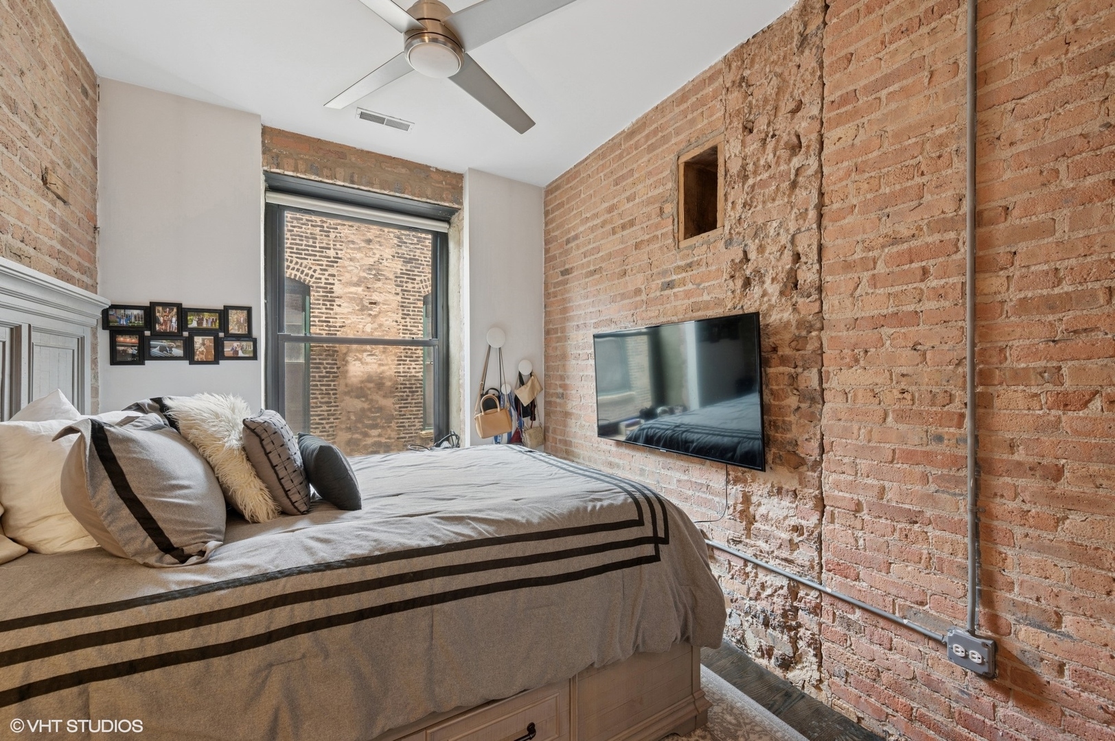 106 North Aberdeen Street, Unit 3A Chicago, IL 60607 - Photo 8 of 13 a bedroom with a bed and a fireplace