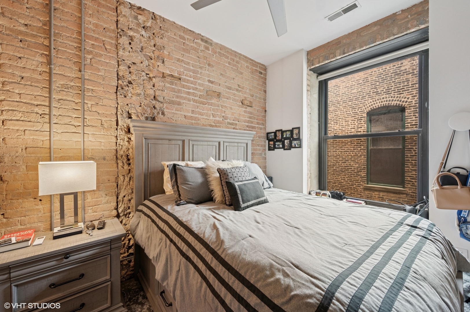 106 North Aberdeen Street, Unit 3A Chicago, IL 60607 - Photo 9 of 13 a bedroom with a bed and a lamp on dresser