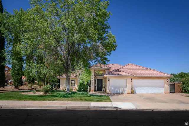 3034 Swiss Drive Santa Clara, UT 84765 - Photo 10 of 59 Single-story residence featuring a tile roof, stucco exterior, and an attached three-car garage