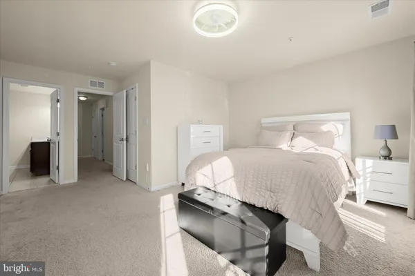 a bedroom with a bed and a lamp