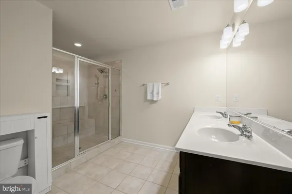 a bathroom with a sink a shower and a mirror