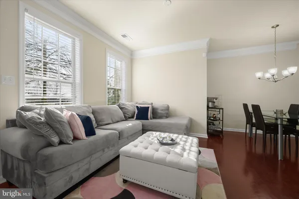 a living room with furniture wooden floor and a table