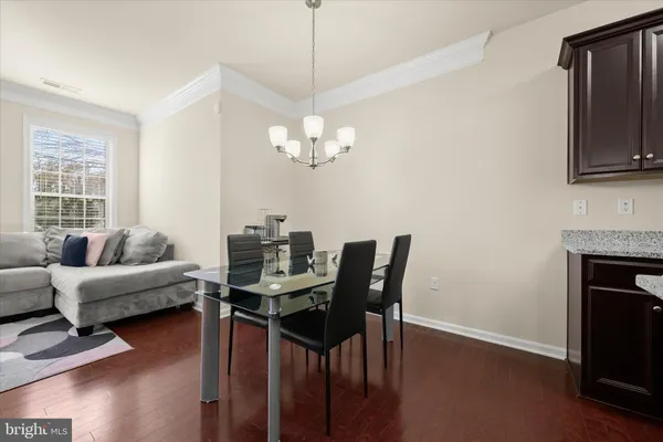 a living room with furniture a fireplace and a chandelier