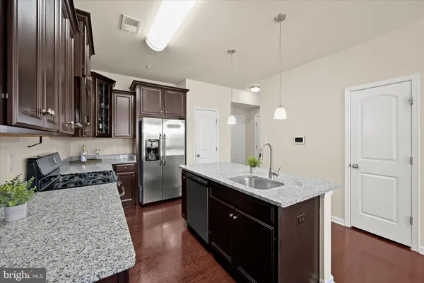 a kitchen with a refrigerator and a sink