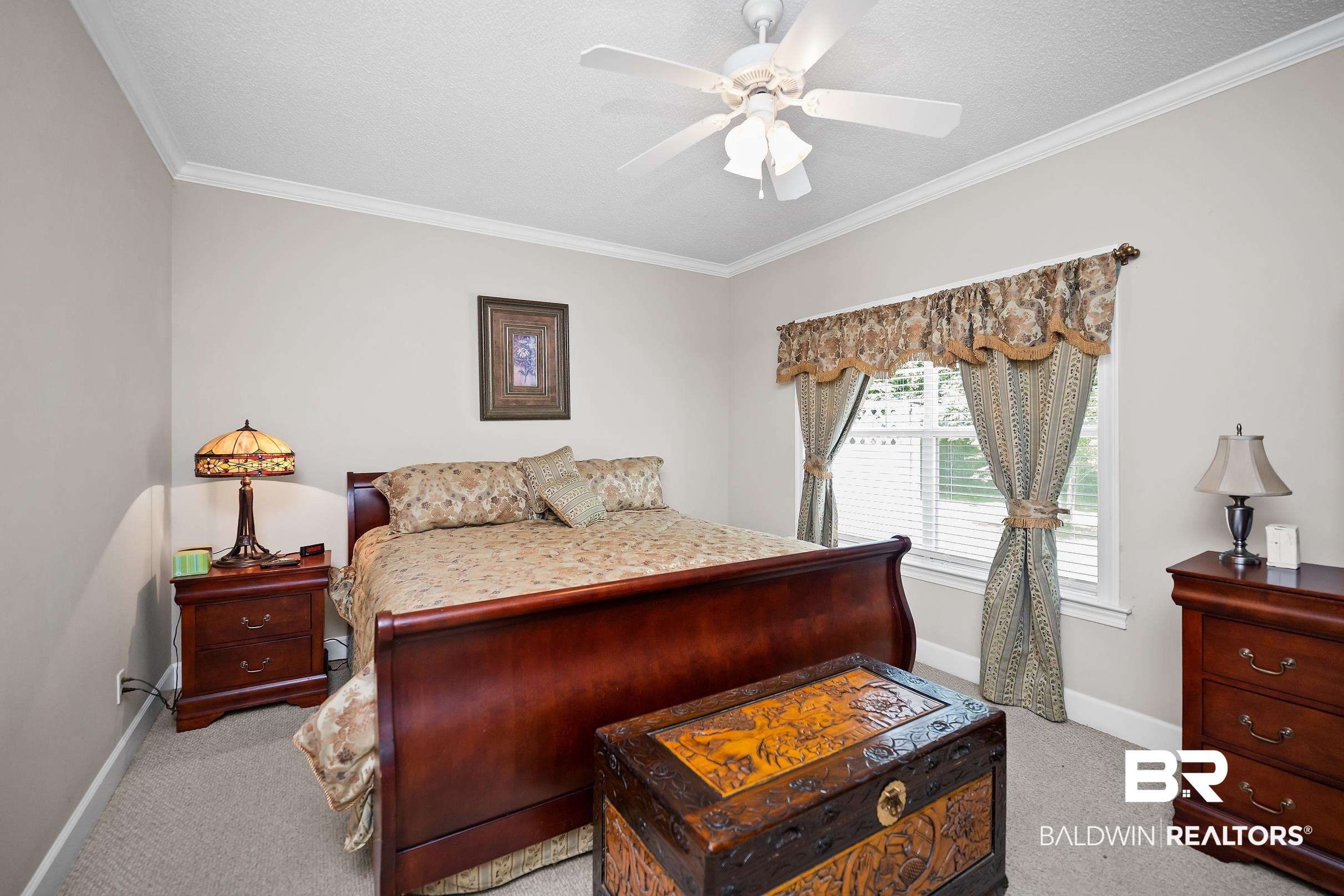 430 West Fort Morgan Road, Unit 704 Gulf Shores, AL 36542 - Photo 11 of 35 Neutral wall paint, crown molding, and a ceiling fan with integrated lighting