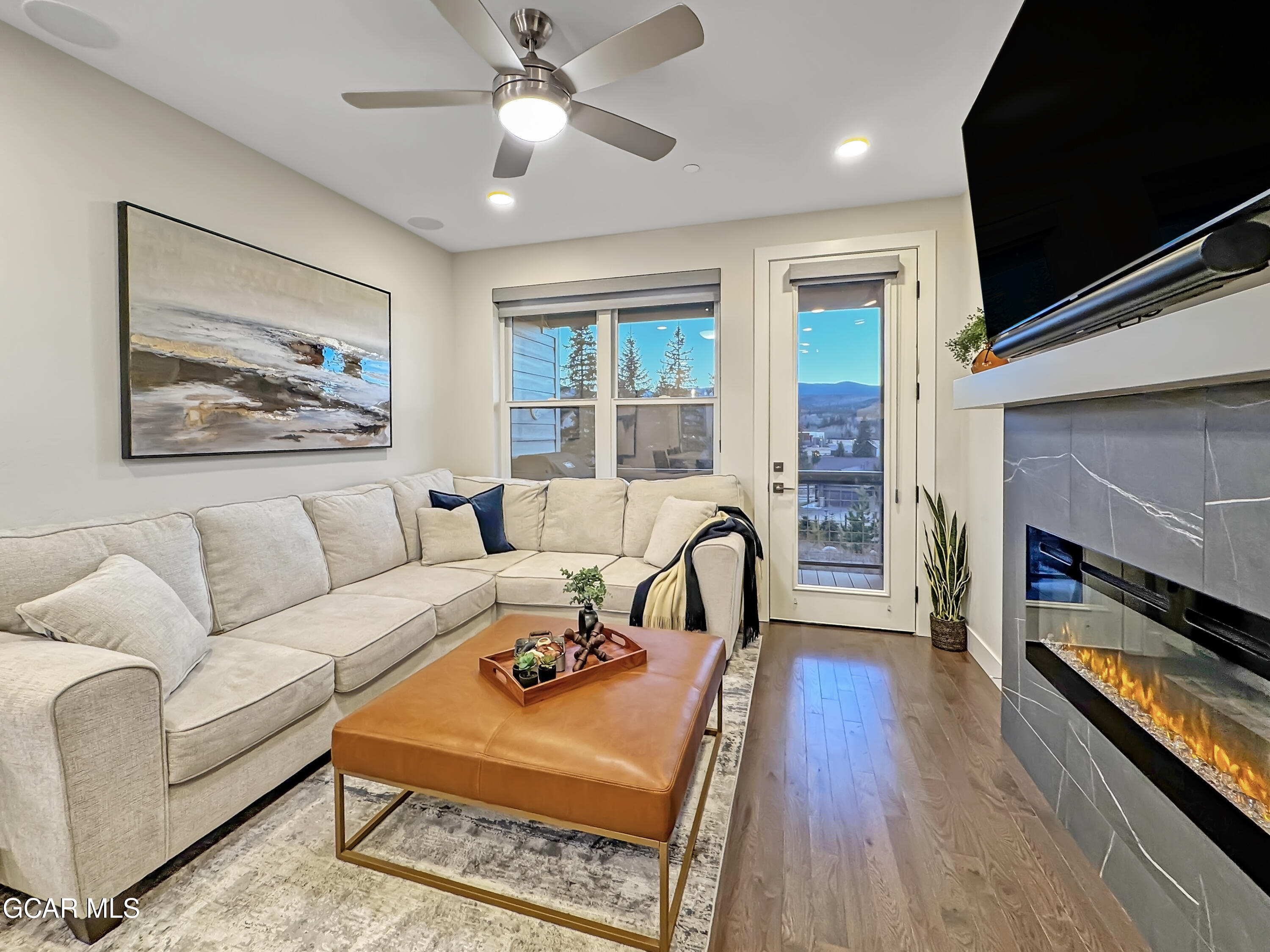 166 Homestead Loop Fraser, CO 80442 - Photo 19 of 56 a living room with furniture a flat screen tv and a fireplace