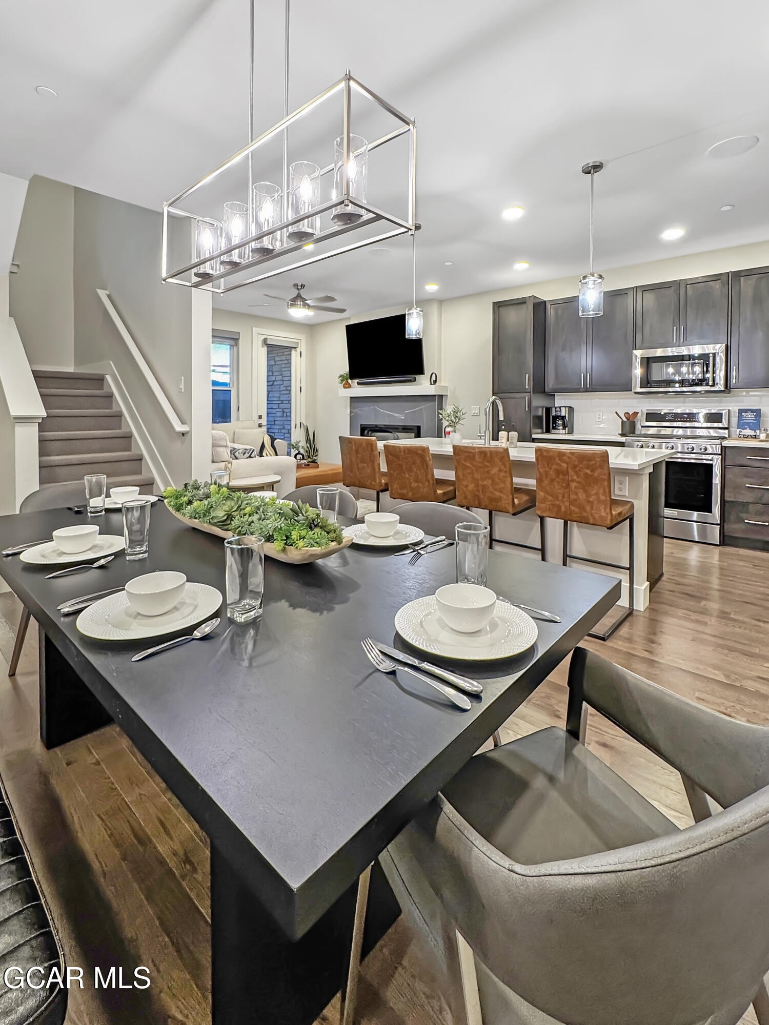 166 Homestead Loop Fraser, CO 80442 - Photo 34 of 56 a living room with stainless steel appliances kitchen island granite countertop a table chairs and a stove