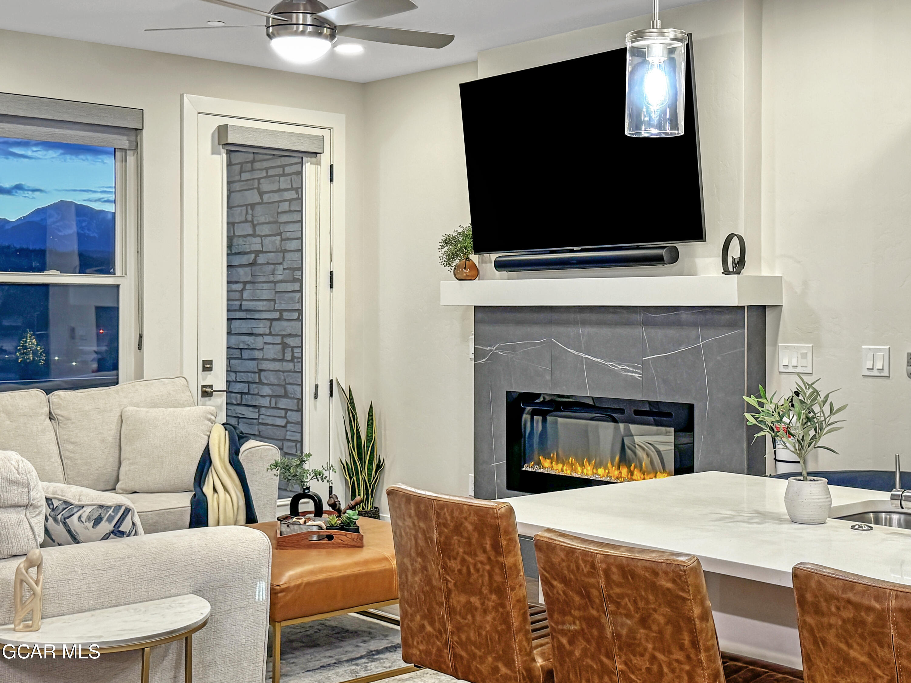 166 Homestead Loop Fraser, CO 80442 - Photo 36 of 56 a living room with furniture a fireplace and a flat screen tv