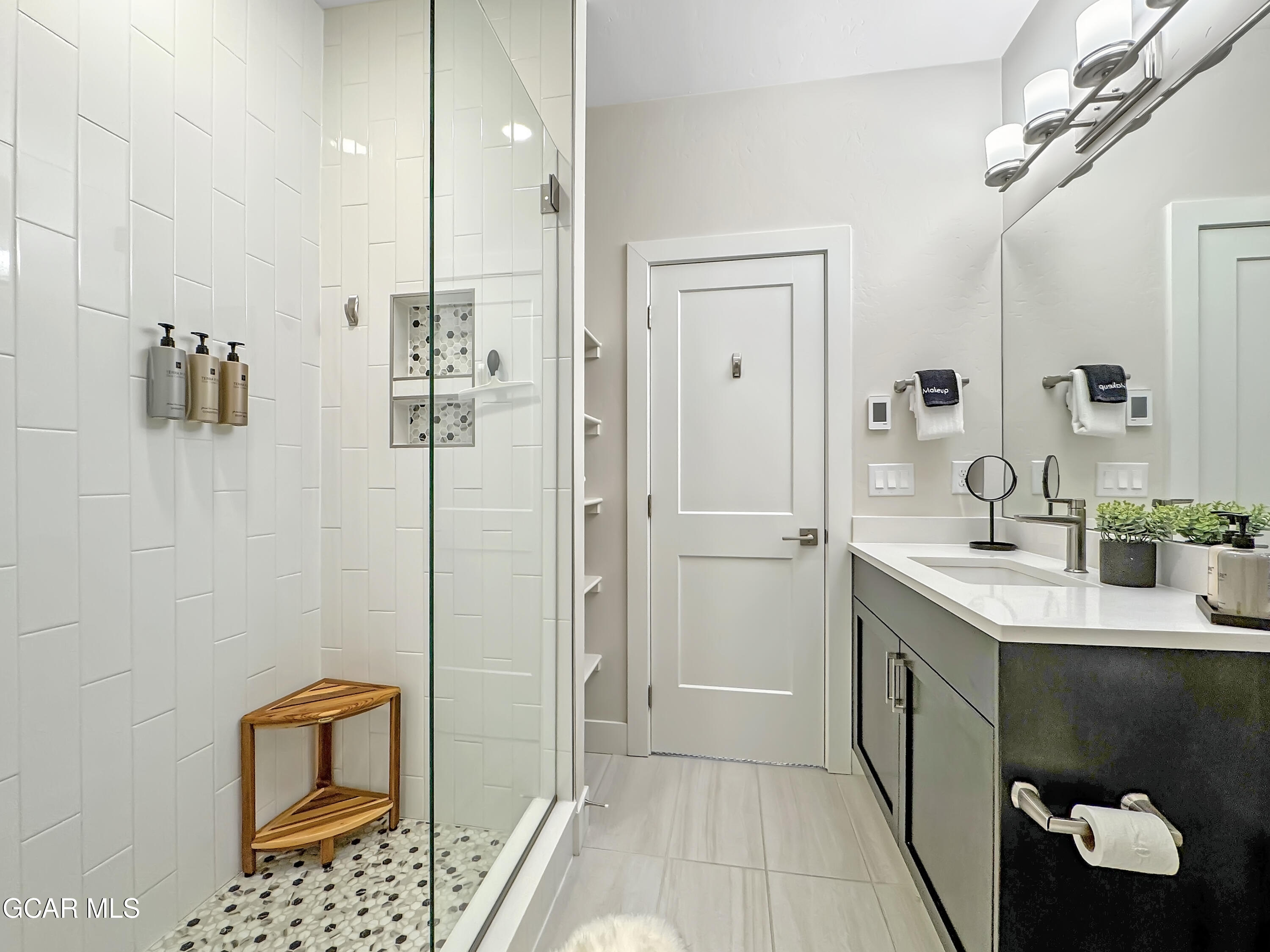 166 Homestead Loop Fraser, CO 80442 - Photo 44 of 56 a spacious bathroom with a shower a sink and a mirror