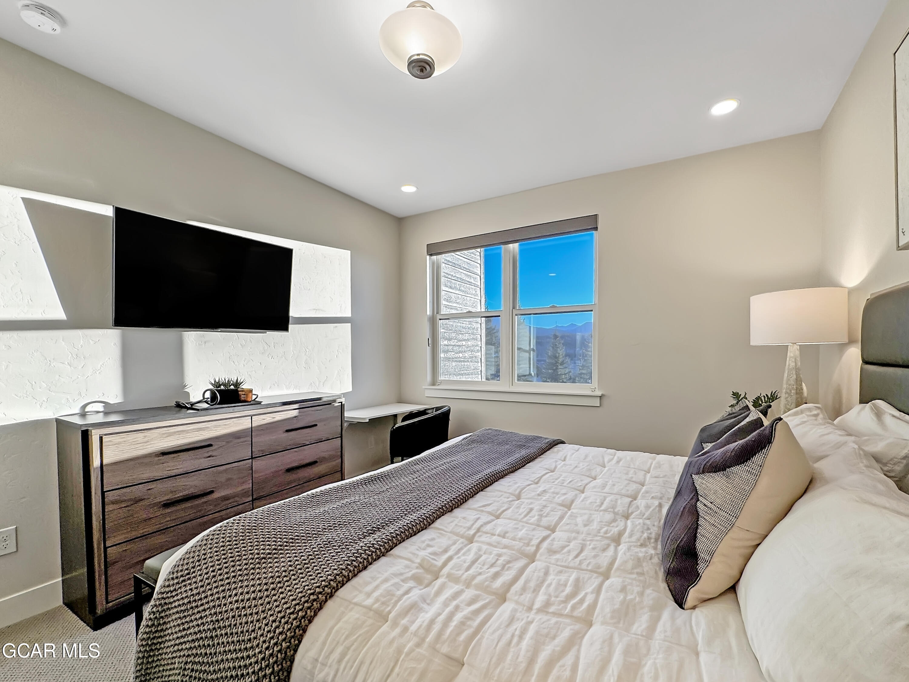 166 Homestead Loop Fraser, CO 80442 - Photo 46 of 56 a bedroom with a bed and a flat screen tv