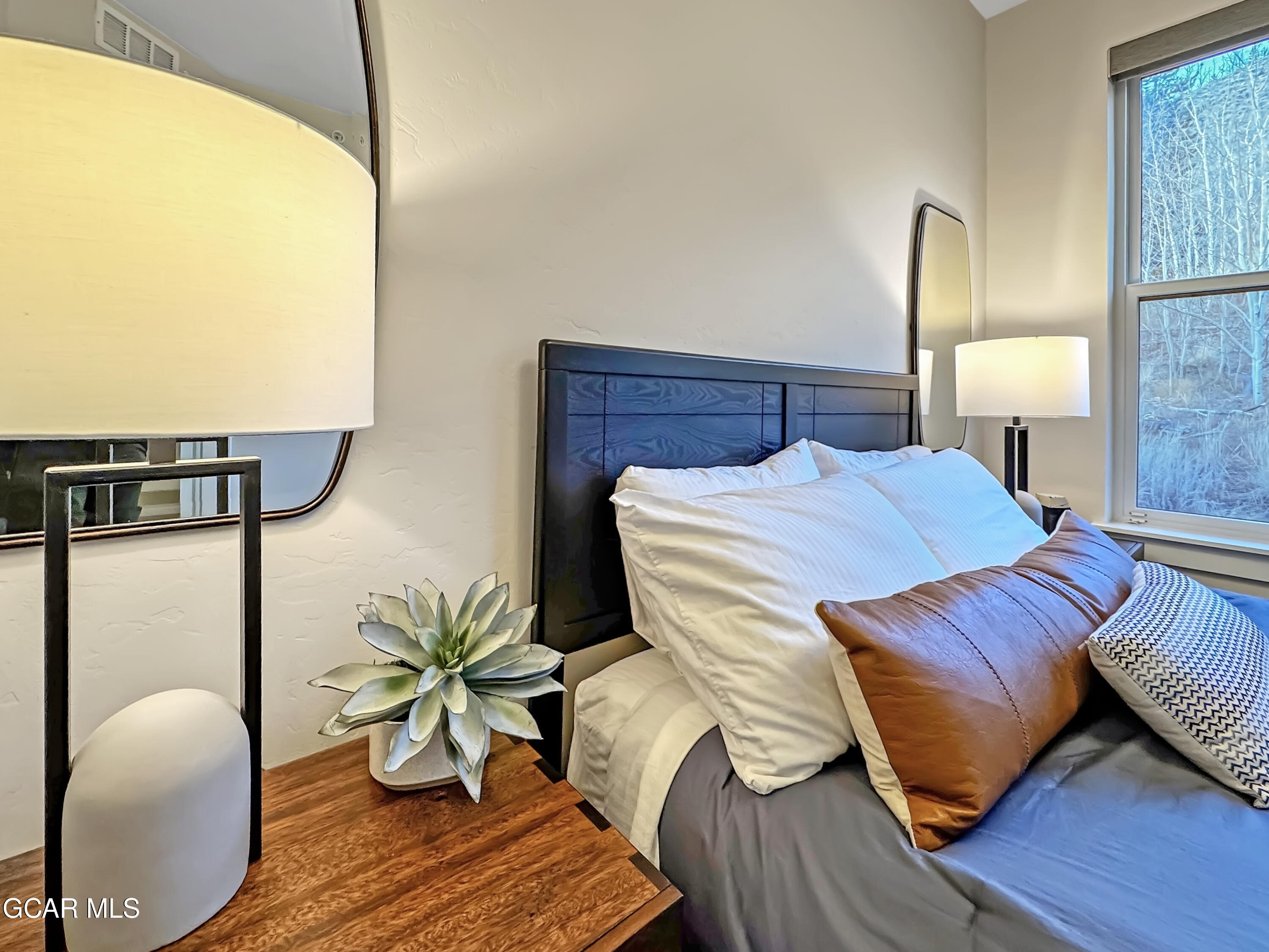 166 Homestead Loop Fraser, CO 80442 - Photo 49 of 56 a bedroom with a bed and dresser with wooden floor