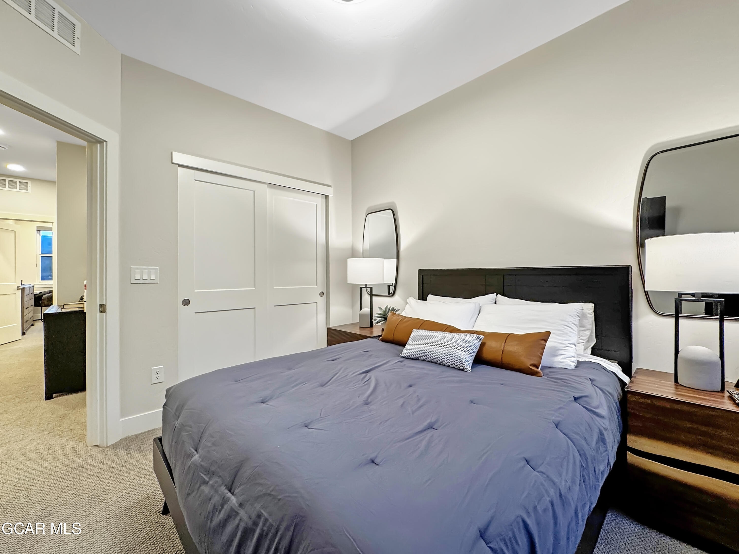 166 Homestead Loop Fraser, CO 80442 - Photo 50 of 56 a bedroom with a bed and lamp on dresser