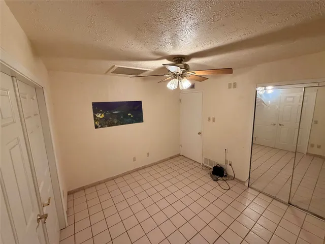 a view of a livingroom with a furniture and chandelier fan