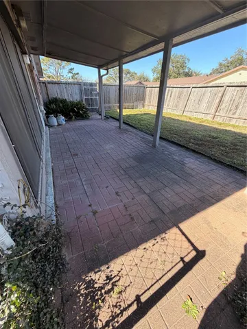 a view of a house with a yard and wooden fence