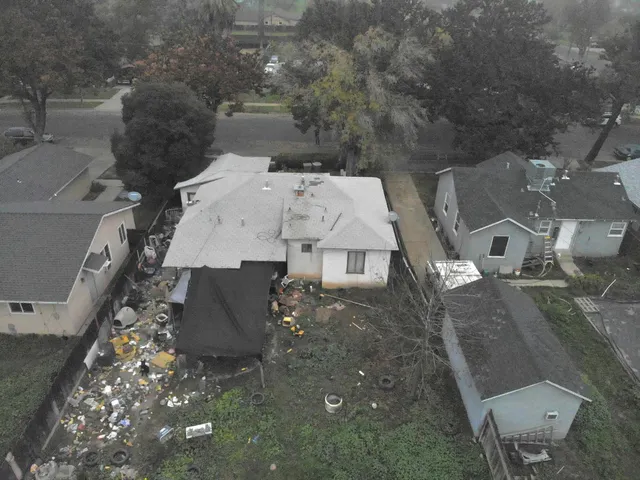 an aerial view of a house with a yard