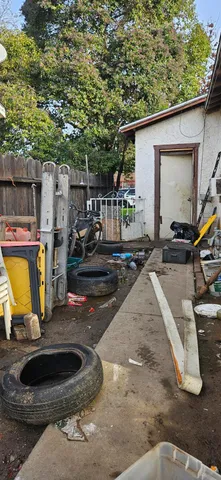 a view of a chairs and table in backyard