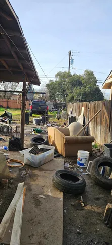 a backyard of a house with barbeque oven