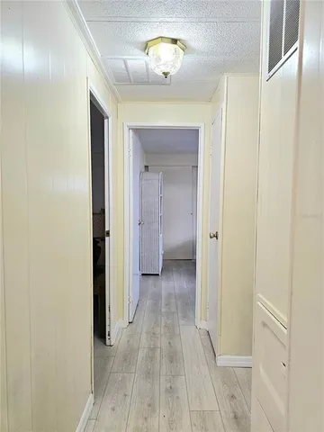 a view of a hallway with wooden floor