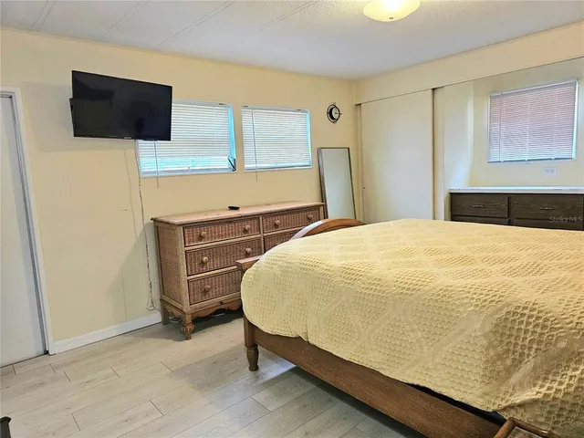 a bedroom with a bed and a flat screen tv