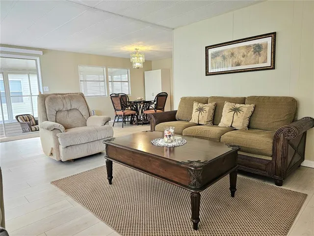 a living room with furniture a rug and a table