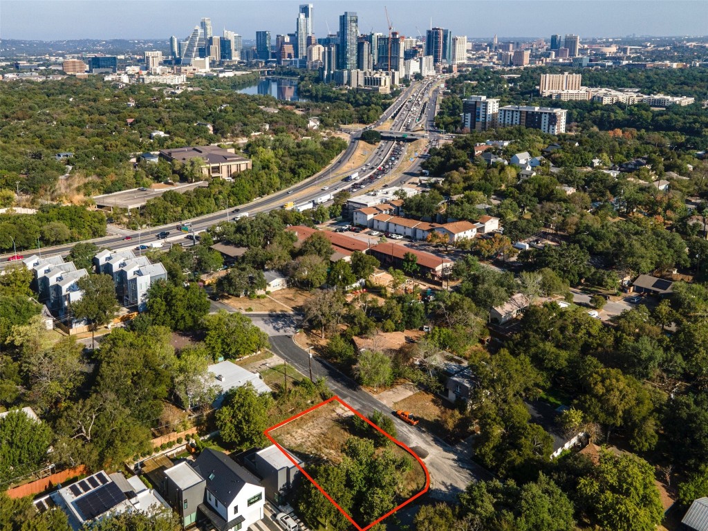 an aerial view of residential houses with city view