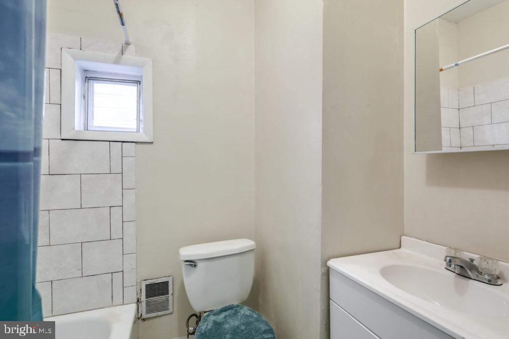 2008 South 4th Street, Unit 2 Philadelphia, PA 19148 - Photo 6 of 7 a bathroom with a toilet sink and mirror