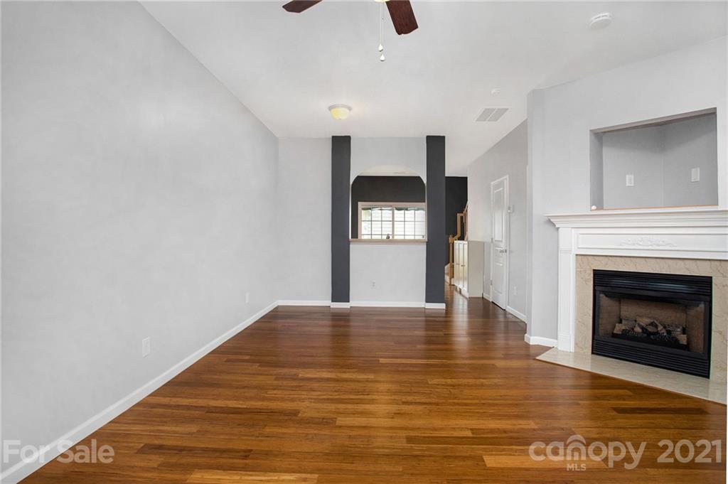1104 Drummond Lane Matthews, NC 28104 - Photo 12 of 20 a view of an empty room with window and fireplace