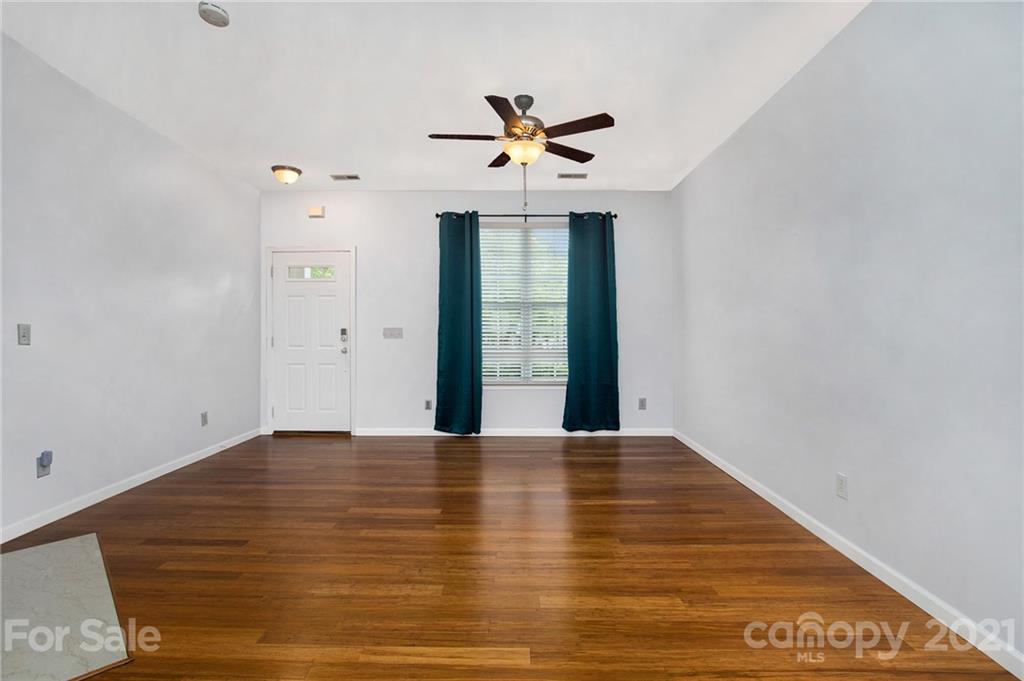 1104 Drummond Lane Matthews, NC 28104 - Photo 13 of 20 a view of an empty room with window and ceiling fan