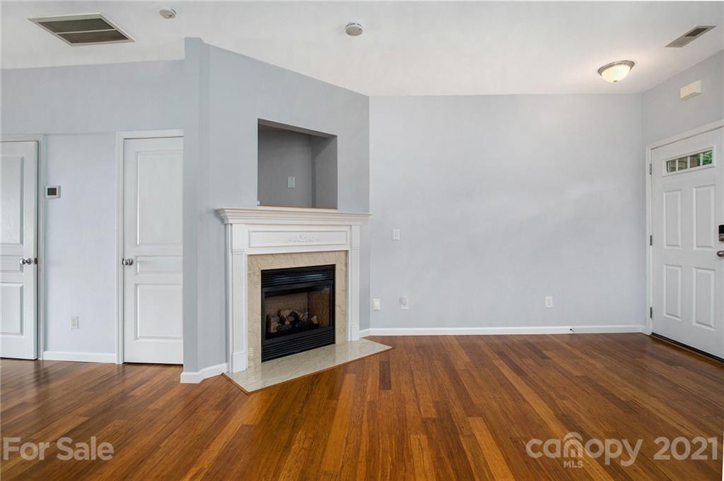 1104 Drummond Lane Matthews, NC 28104 - Photo 5 of 20 a view of empty room with wooden floor and fireplace