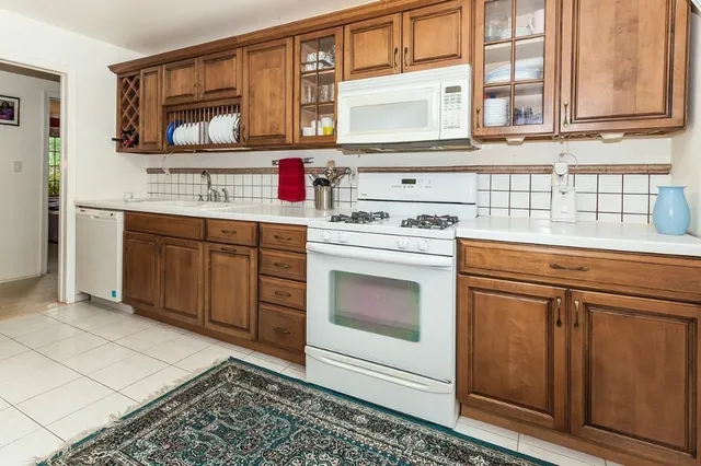 a kitchen with granite countertop a sink and cabinets