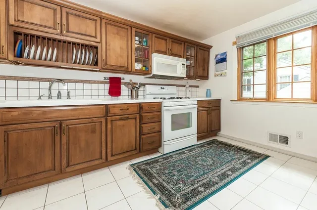 a kitchen with stainless steel appliances granite countertop a sink stove and cabinets