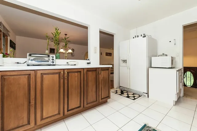 a kitchen with refrigerator and cabinets