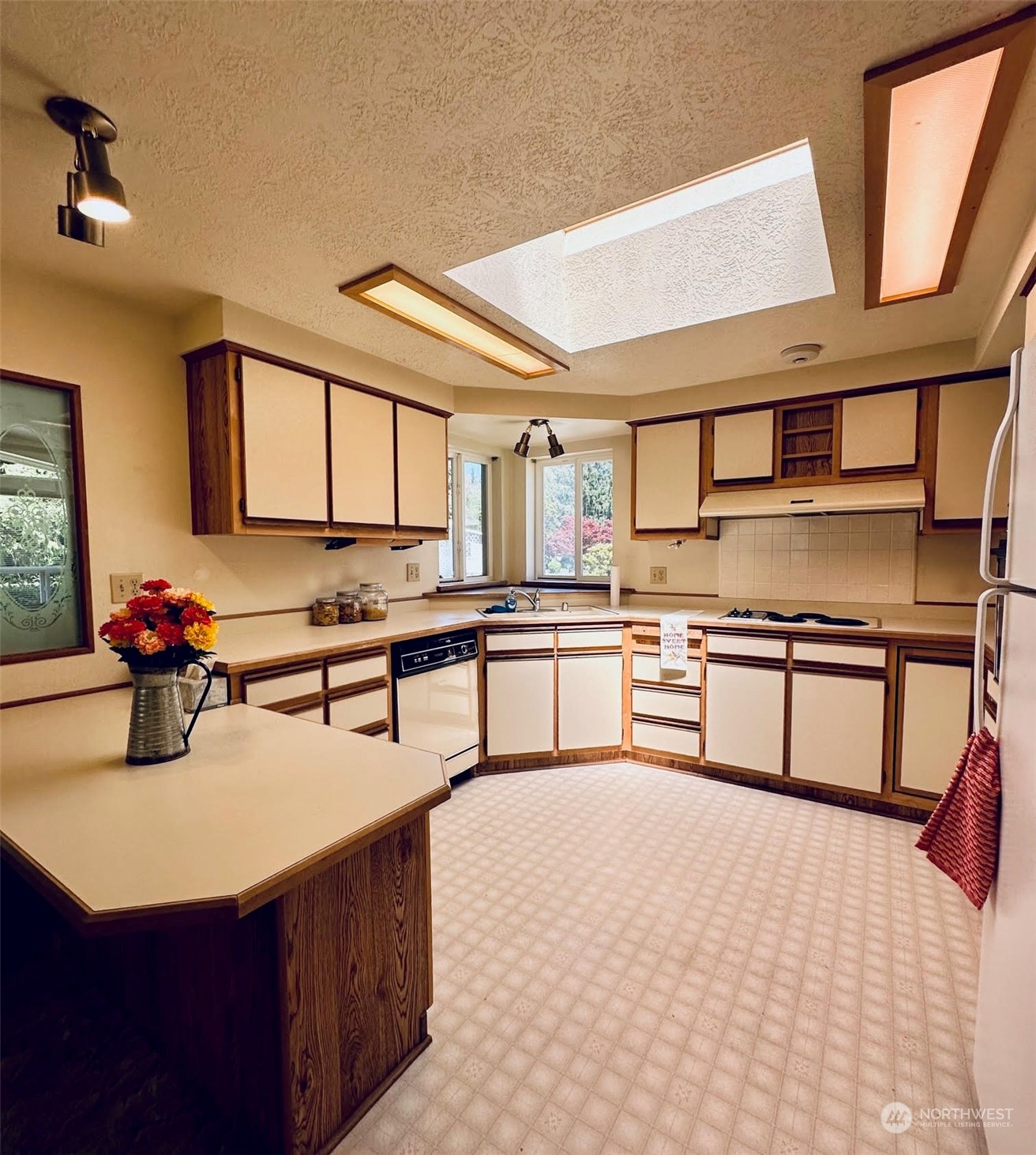 2283 Rincon Avenue, Unit 92 Enumclaw, WA 98022 - Photo 13 of 25 a kitchen with stainless steel appliances kitchen island granite countertop a sink counter space and cabinets