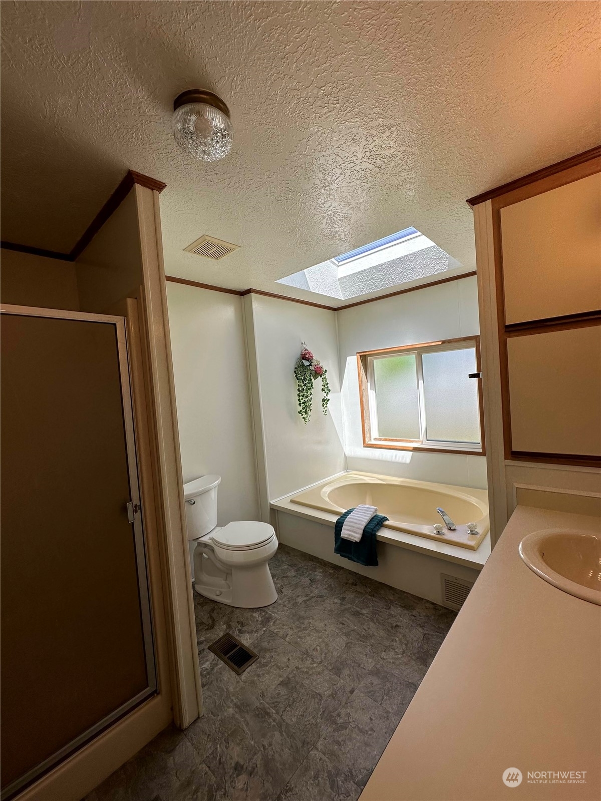 2283 Rincon Avenue, Unit 92 Enumclaw, WA 98022 - Photo 18 of 25 a bathroom with a sink a toilet and a shower