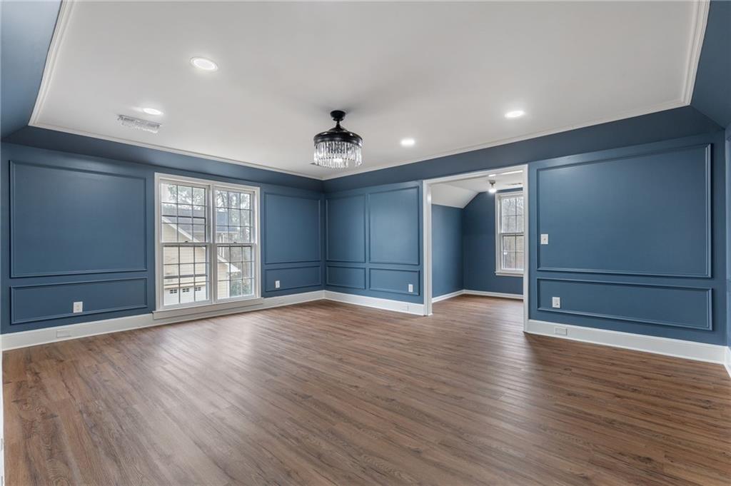 808 Valbrook Court Southwest Lilburn, GA 30047 - Photo 12 of 39 a view of an empty room with wooden floor and a window