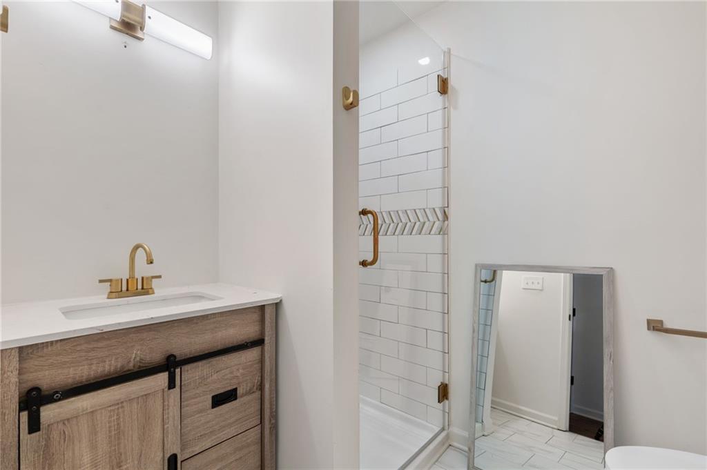 808 Valbrook Court Southwest Lilburn, GA 30047 - Photo 22 of 39 a bathroom with a sink and a mirror