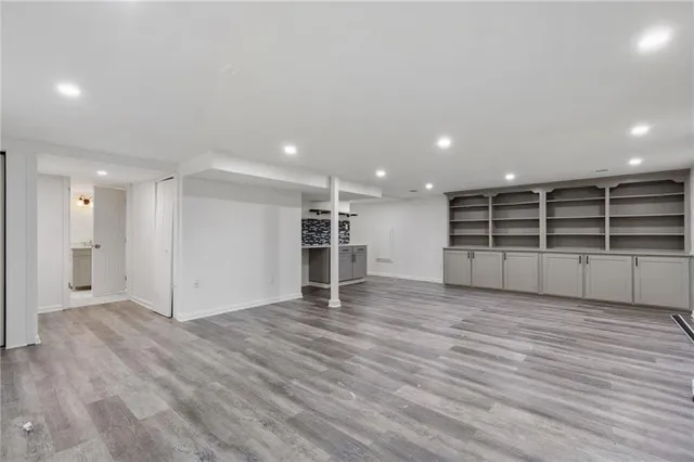 a view of empty room with wooden floor
