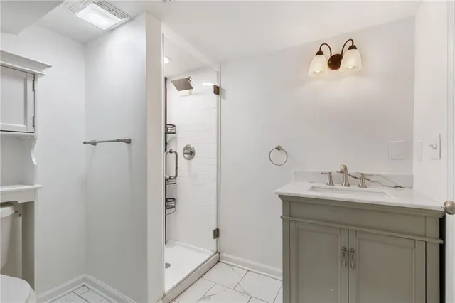 a bathroom with a shower sink and mirror