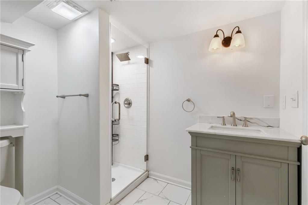 808 Valbrook Court Southwest Lilburn, GA 30047 - Photo 25 of 39 a bathroom with a shower sink and mirror